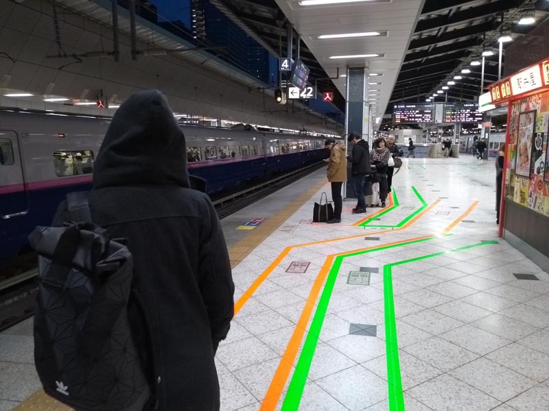 people standing in line for the shinkansen